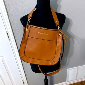 Can be worn as a crossbody/ shoulder bag, with adjustable/ removable strap